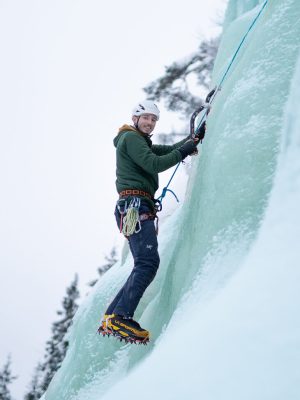Guide climbing Ice wall in Korouma Frozen waterfalls in Lapland.